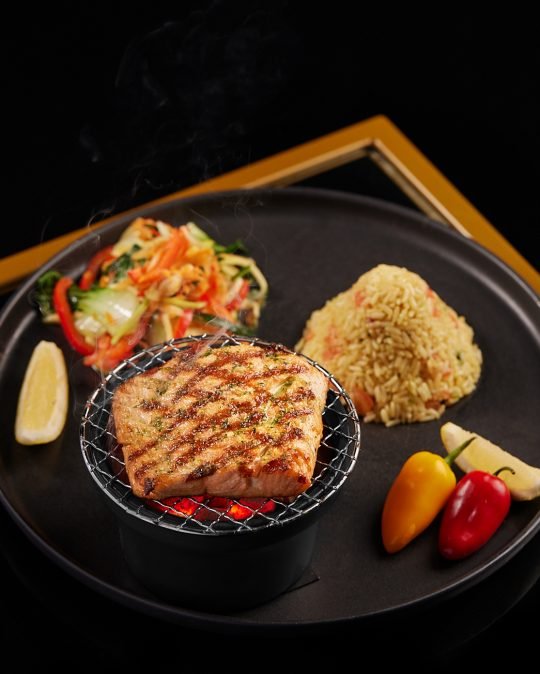 Close-up of a beautifully plated gourmet steak with mashed potatoes and seasonal vegetables, captured for a restaurant menu