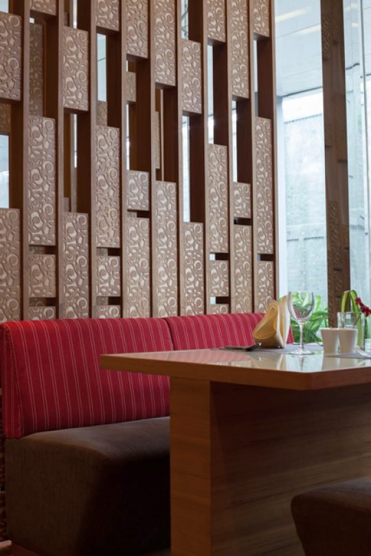 Stylish boutique hotel room with cozy bedding and warm lighting, captured for a hospitality brand