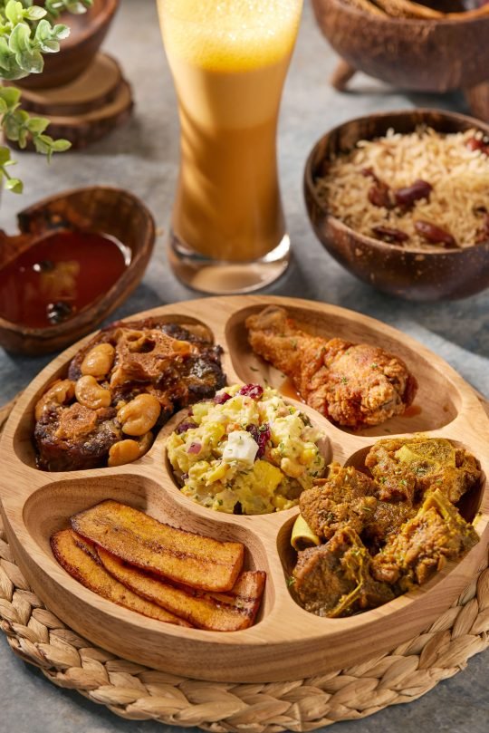 Colorful African dishes arranged on a communal platter, captured for a family-style food campaign