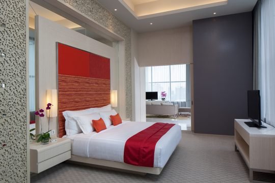 Bright and spacious hotel suite with natural light and minimalist furniture