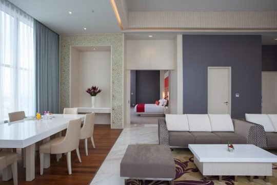 Modern hotel room with king-size bed and neutral decor, photographed for a luxury Toronto hotel