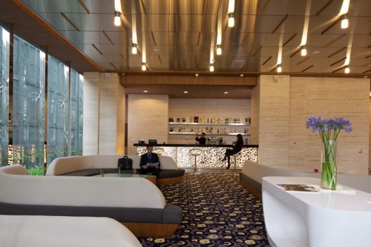 Stylish boutique hotel room with cozy bedding and warm lighting, captured for a hospitality brand