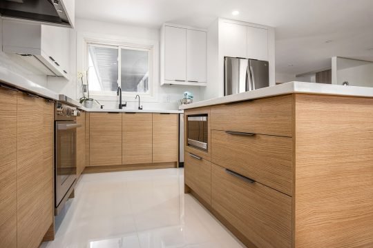 Open-concept kitchen with large island and pendant lighting in a modern Toronto condo
