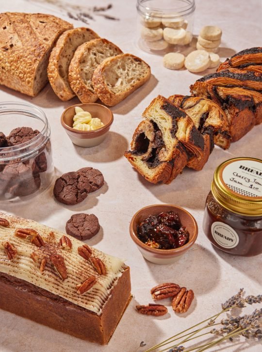 Sliced loaf of Bready Café’s homemade banana bread with a cup of coffee, perfect for a café menu display