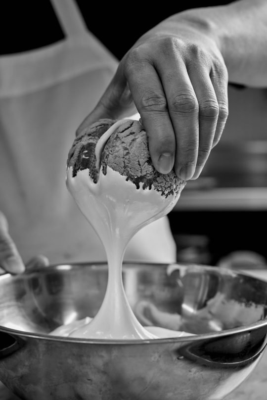 Soft brioche buns arranged on a linen napkin, photographed for a local Toronto bakery campaign