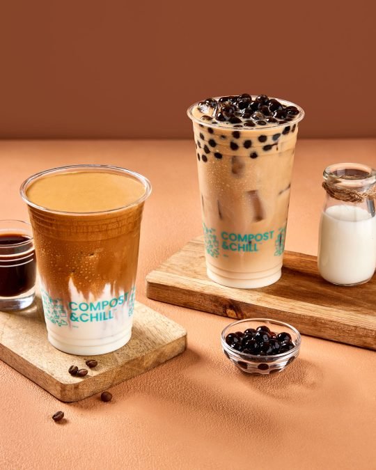Colorful bubble tea with tapioca pearls and ice, served in a clear cup, photographed for a beverage brand