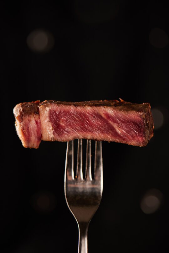Still life Steak on Fork minimal styling and high-end food photography,professionally photographed.