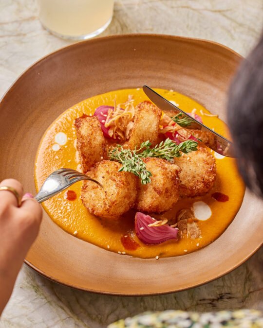 Photograph of someone having lunch, focus on the food POV from her shoulder