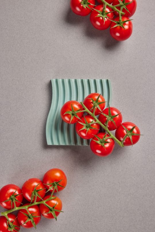 Fresh heirloom tomatoes on a wooden cutting board, photographed for a farm-to-table brand in Toronto