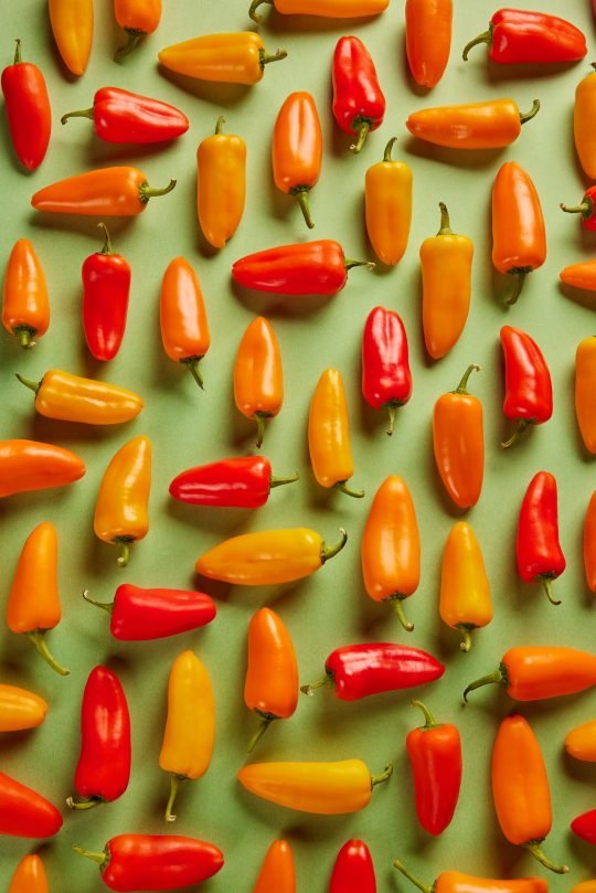 Fresh small bell pepper on a wooden cutting board, photographed for a farm-to-table brand in Toronto