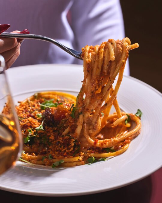 Close up of pasta being scope with fork