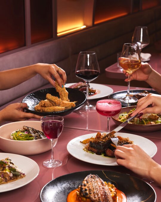 Friends having a dinner together in perfect dining moment at restaurant