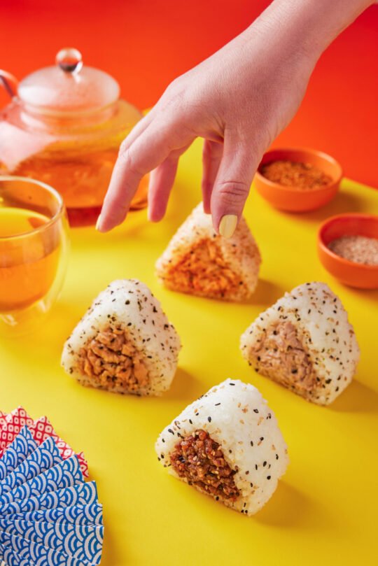 Onigiri sushi on vibrant colour with minimal styling and high-end food photography,professionally photographed.
