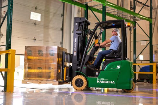 Industrial photography of worker and forklift