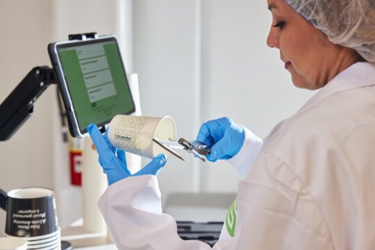 Manufacture photography focus on A worker inside the lab to test the quality of the product item, bright lighting and lab feel
