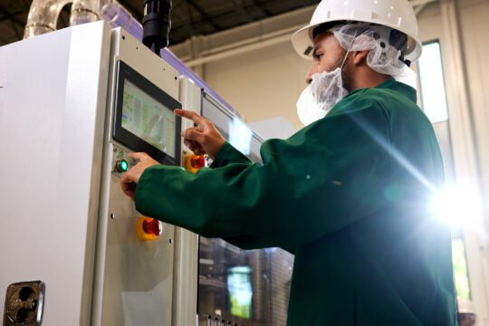 Industrial commercial photography scene inside a modern paper cup manufacturing facility, showcasing food-grade raw materials used for premium paper cup production. bright low angle