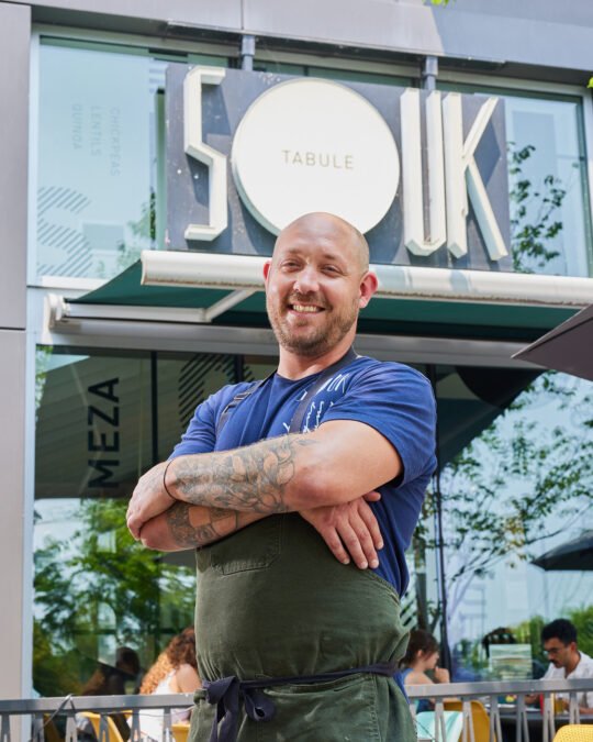 Portrait of chef standing in front of the store