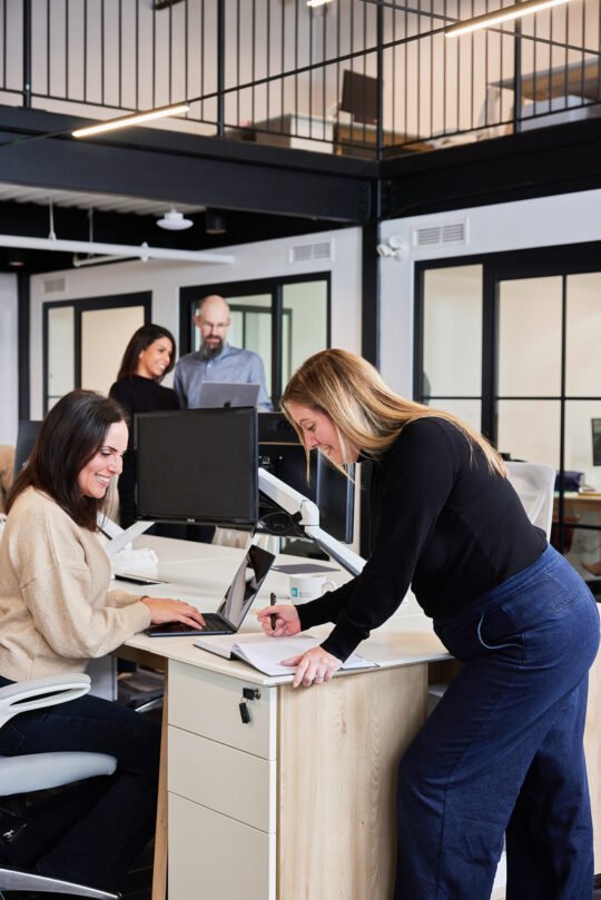 Portrait of group of people in the middle of kitchen area meeting time