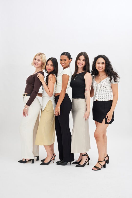 Group photo of staff standing together against white background