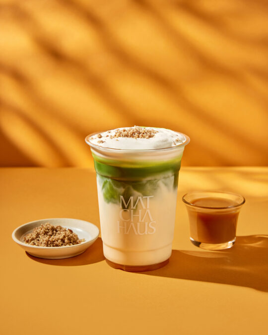 Caramel salted Matcha on the yellow surface and background with shadow coming from left side