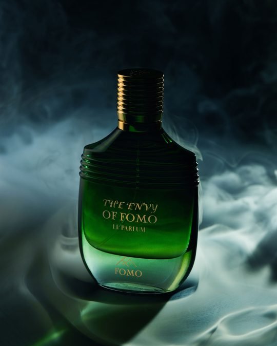 High-quality close-up shot of luxury perfume bottle on a white marble surface and dreamy feel