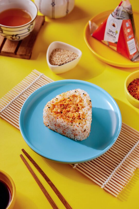 Onigiri sushi on vibrant colour with minimal styling and high-end food photography,professionally photographed.