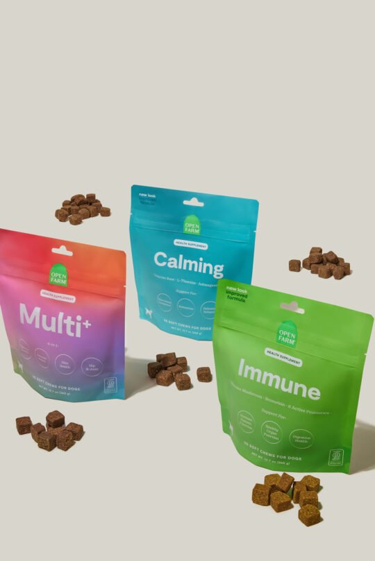 Photoshoot of 3 products dog supplement arrange on the eggshell background. cubes and kibble in front of the packaging. Product photoshoot of dog supplements