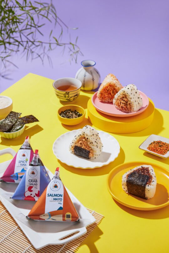 Onigiri sushi on vibrant colour with minimal styling and high-end food photography,professionally photographed.
