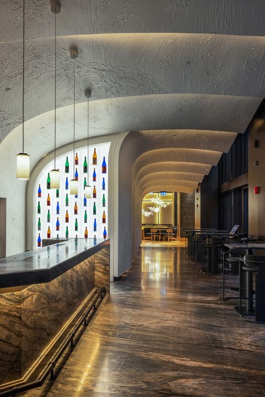 Stunning restaurant interior with open kitchen and polished wood elements, captured in Toronto